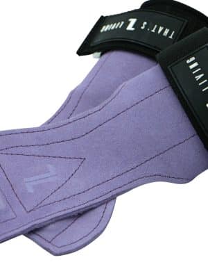 The IronHide Lifting Straps are purple suede with black wrist bands, featuring "THAT’S LIVING" and "Z" in white text on the black section.