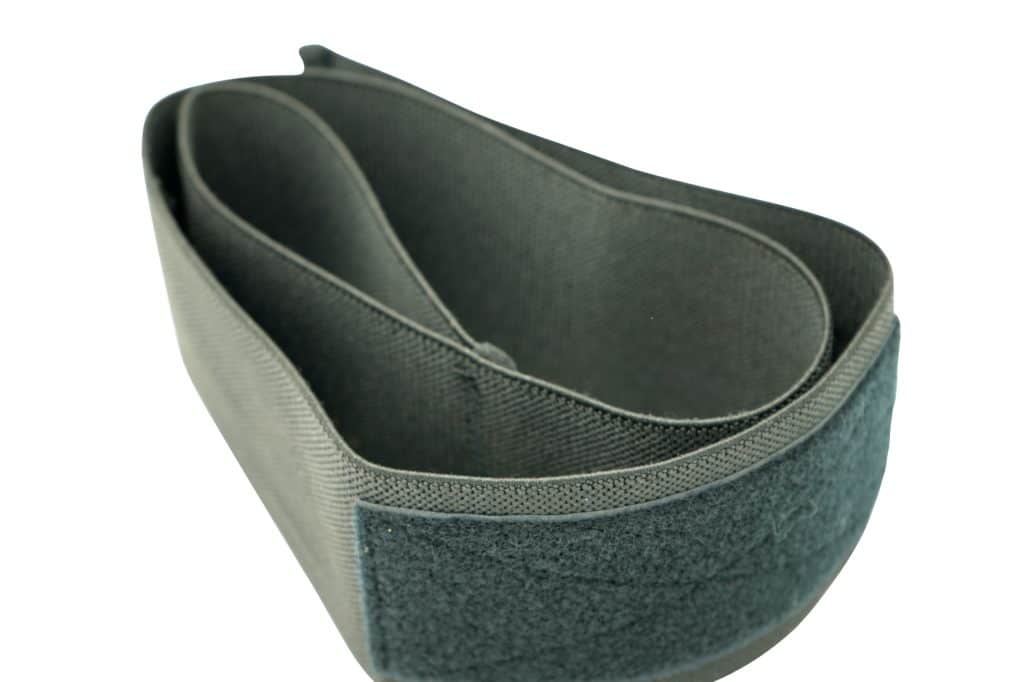 A close-up view of the Original Elbow Wraps, featuring a black adjustable elastic strap with a hook-and-loop fastener, ideal for securing or bundling items.