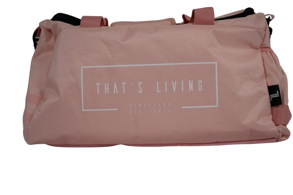 The TRIARC Duffle Bag - Pink features “THAT’S LIVING ATHLETICS EST. 2017” in white on the side, two short handles, and a zipper closure.