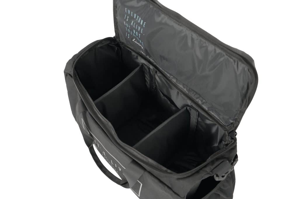 The TRIARC Duffle Bag, shown with its top open on a white background, reveals three padded adjustable compartments inside. The lid features a printed design with text.