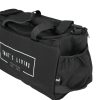 The TRIARC Duffle Bag is black with handles, a zipper, a side pocket, and a white rectangular "THAT'S LIVING" logo on the front. It is pictured against a white background.