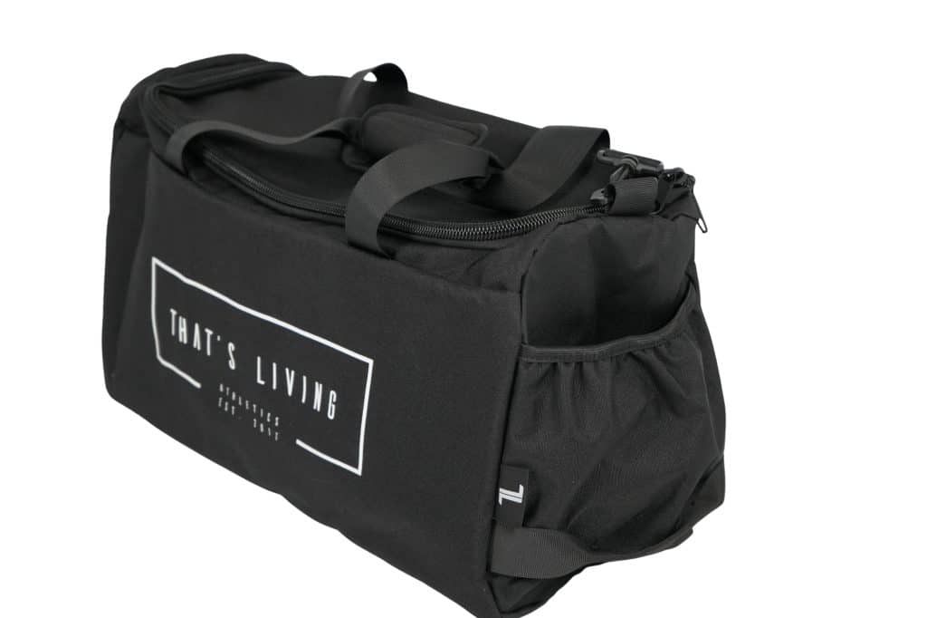 A black duffel bag with handles and a front pocket, featuring the text "THAT'S LIVING" in white on the side. The bag also has a side pouch and a zipper closure on top.
