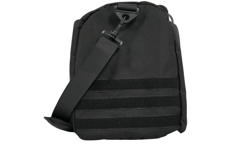 The TRIARC Duffle Bag is black with a thick adjustable strap, velcro strips on the front, and a top plastic buckle. Its simple, utilitarian design makes it ideal for everyday use.