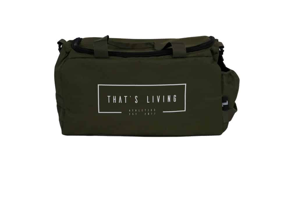 A green duffel bag with black handles and a white rectangular logo on the front that reads, "THAT'S LIVING ATHLEISURE EST. 2021," against a white background.