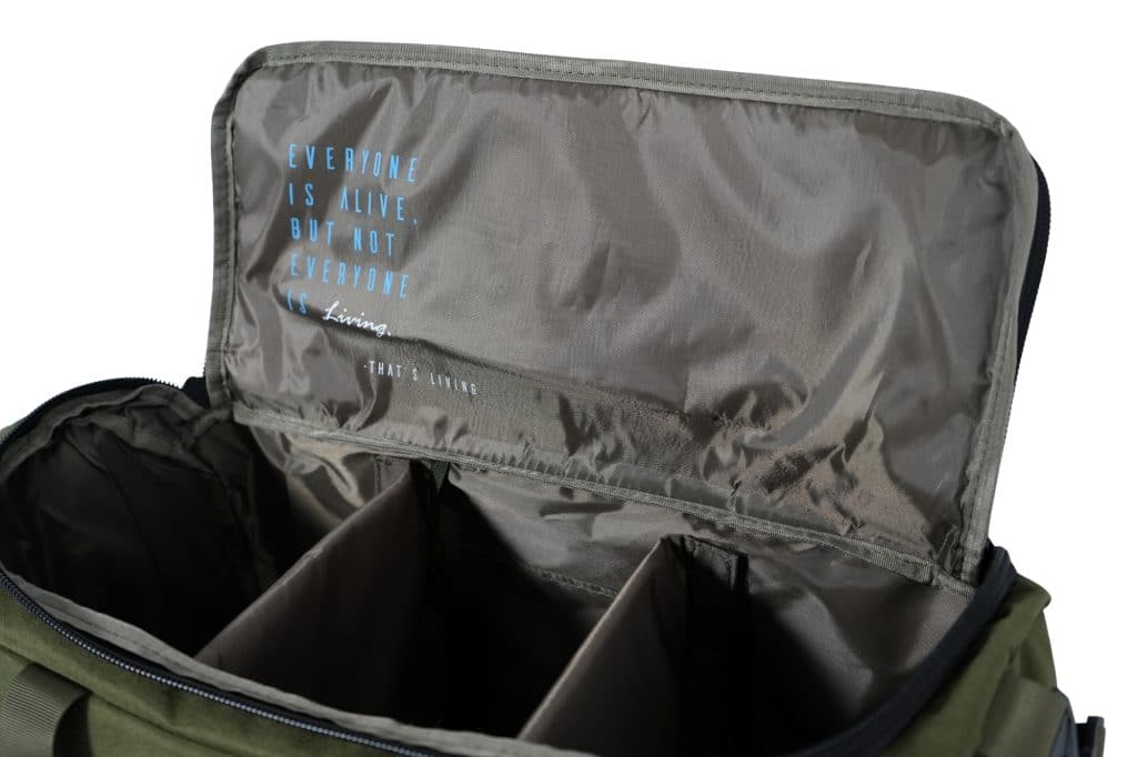 The TRIARC Duffle Bag is an open khaki and gray bag with internal dividers and a flap featuring blue and white text: "EVERYONE IS ALIVE, BUT NOT EVERYONE IS Living. THAT'S LIVING.