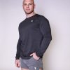 Grey 1 A muscular man with a shaved head wears a black long-sleeve shirt and gray athletic shorts, both with a small "Z" logo, standing confidently against a plain light background.